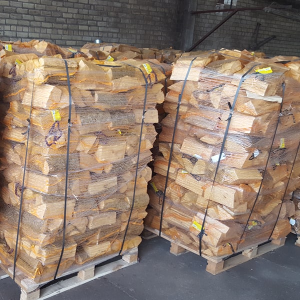 Pallets of birch firewood net bags in the warehouse