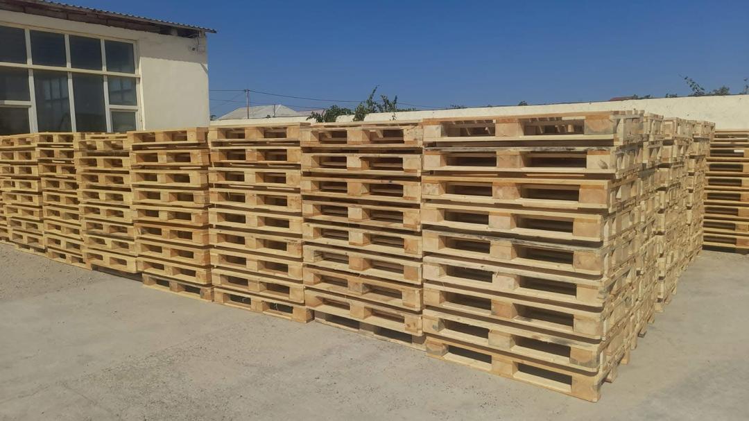 Large blocks of EPAL euro pallets stored outdoors