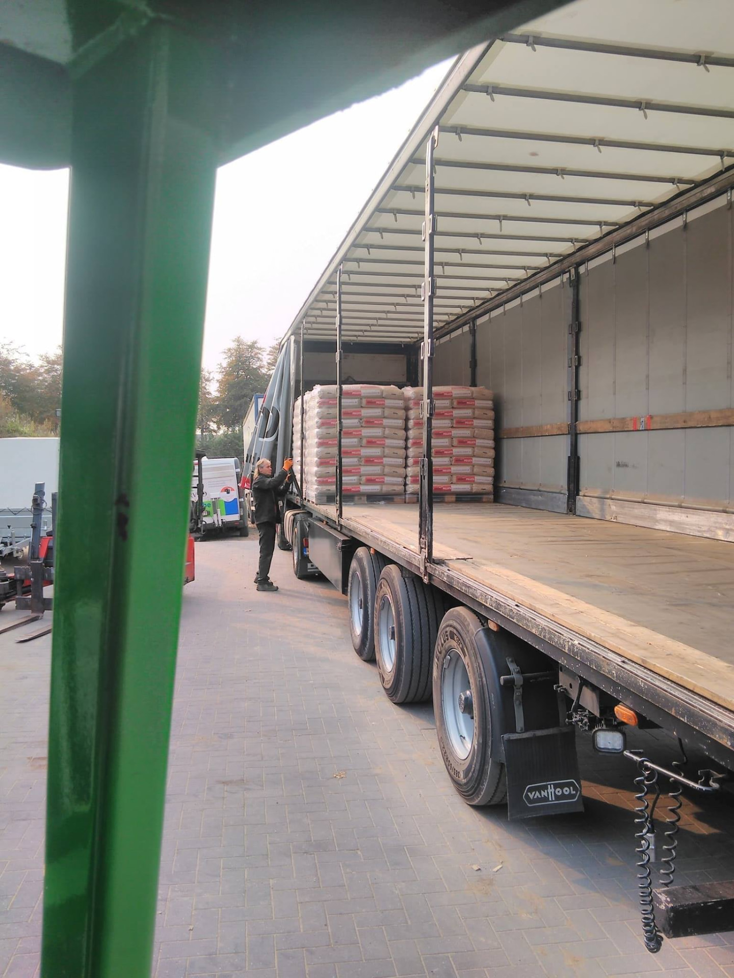 Wood pellet pallets being loaded onto a truck